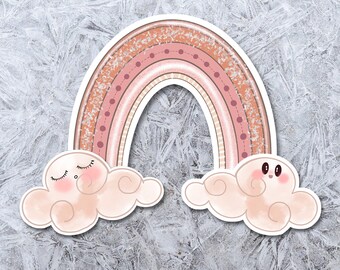 May include: A set of stickers featuring a pink and orange rainbow with two clouds. One cloud has a sleepy face and the other has a happy face.