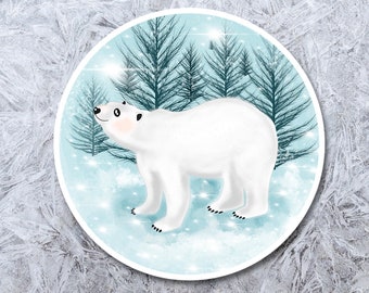 May include: A 2.5 inch round sticker featuring a white polar bear standing in a snowy forest with blue pine trees. The background is a light blue with white snowflakes.