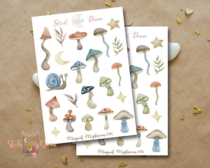 May include: A sheet of stickers featuring watercolor illustrations of mushrooms in various colors and styles. The stickers are labeled "Magical Mushroom 045" and include a snail, stars, and crescent moons.
