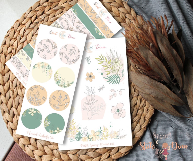 May include: A set of floral themed stickers with a pastel color scheme. The stickers include a sheet of round labels with floral patterns, a sheet of pastel spring flowers, and a sheet of floral patterned washi tape.