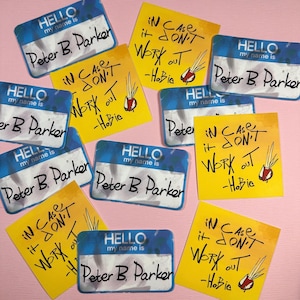 May include: A set of ten yellow and blue name tag stickers with the text "HELLO my name is Peter B. Parker" and "IN CASE it DON'T WORK OUT -Hobie".