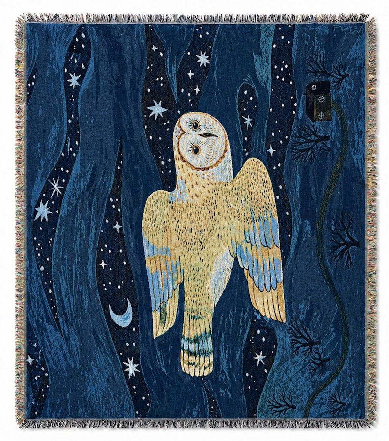 May include: A woven throw blanket featuring a large owl with outstretched wings against a dark blue night sky filled with stars and a crescent moon. The owl is primarily beige and yellow with blue accents. The blanket has a fringed edge.