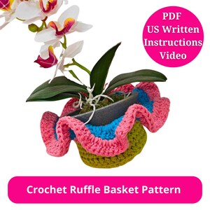 May include: A crochet ruffle basket pattern with a pink, green, and blue ruffle. The basket is holding a potted orchid with white flowers and green leaves. The image includes the text "Crochet Ruffle Basket Pattern" and "PDF US Written Instructions Video".