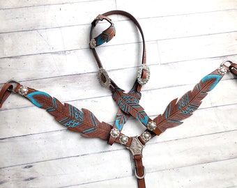 May include: Brown leather horse bridle with turquoise feather design and silver conchos.