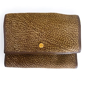 May include: A brown leather wallet with a textured surface and a gold button closure.