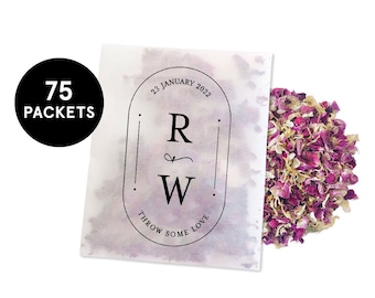 May include: A white paper packet with a black and white label that says "23 January 2022, R & W, Throw Some Love". The packet contains pink and white rose petals.