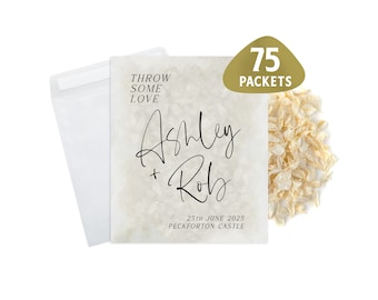 May include: White paper confetti packets with a beige background and black text that reads "Throw some love Ashley + Rob 25th June 2025 Peckforton Castle". The text is in a handwritten font. The packets are labeled with a gold sticker that reads "75 Packets".