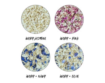 May include: Four circular arrangements of dried flower petals against a white background. The arrangements include ivory jasmine, ivory and pink, ivory and navy, and ivory and blue petals. Text below each circle identifies the petal combinations.