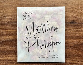 May include: White paper bag with the text "Throw some love" and the names "Matthew + Philippa" in black script. The date "18th May 2024" and the location "Horsley Towers" are printed below the names.