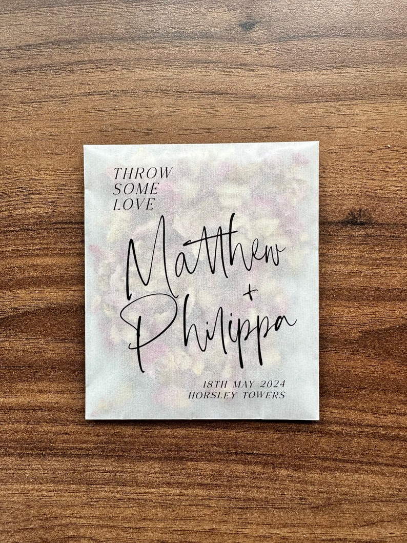 May include: White paper bag with the text "Throw some love" and the names "Matthew + Philippa" in black script. The date "18th May 2024" and the location "Horsley Towers" are also printed in black.