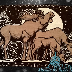 May include: A crochet pattern featuring a brown moose and a fawn standing in a snowy forest under a full moon. The pattern is called "Mosaic by Betsy Sickler".