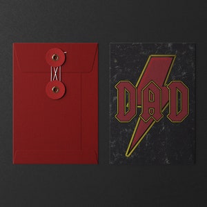 May include: Red envelope with two red buttons and a white string. The envelope is next to a card with a black background and a red lightning bolt with the word "DAD" in red letters.