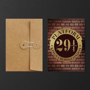 May include: A brown paper envelope with a string closure next to a rectangular sign. The sign features a brick background with a gold emblem that reads "PLATFORM 29 3/4 KINGS CROSS LONDON."