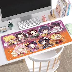 Puede incluir: Un tapete de ratón colorido con un grupo de personajes de anime vestidos con disfraces de Halloween. Los personajes están sobre un fondo degradado con tonos naranja, amarillo y morado. El tapete de ratón tiene un borde cosido y un fondo blanco.