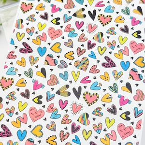 May include: A white background with a repeating pattern of colorful hearts. The hearts are in various styles and designs, including some with geometric patterns, polka dots, and stripes. The hearts are in shades of pink, blue, yellow, and orange.