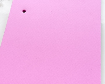 May include: Pink foam cake decorating board with multiple holes for cake decorating.