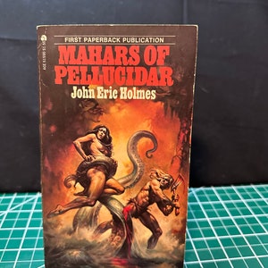 May include: A paperback book cover with a red and white title "Mahars of Pellucidar" by John Eric Holmes. The cover art features a woman in a jungle setting with a large, green, tentacled creature.