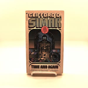 May include: A vintage paperback book cover featuring a science fiction illustration of a man in a spacesuit standing in front of a control panel. The title of the book is "Time and Again" by Clifford D. Simak, a Hugo Award-winning author.