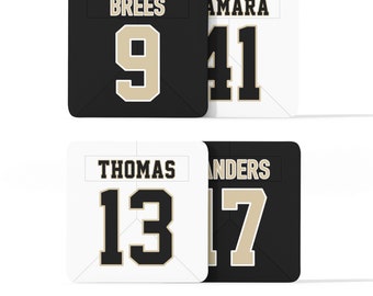 May include: Four black and white jersey squares with player names and numbers. The top left square reads "BREES 9", the top right square reads "AMARA 41", the bottom left square reads "THOMAS 13", and the bottom right square reads "SANDERS 17".