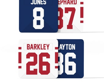 May include: Four white and blue jersey squares with red numbers and names. The top left square reads "JONES 8", the top right square reads "EPHARD 37!", the bottom left square reads "BARKLEY 26!" and the bottom right square reads "LAYTON 36".