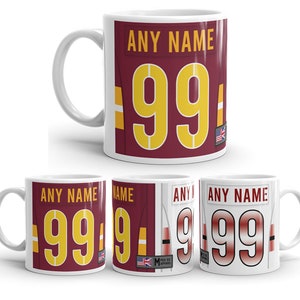 May include: Set of four white ceramic mugs with a red and yellow design. The mugs feature the text "ANY NAME" and the number "99".
