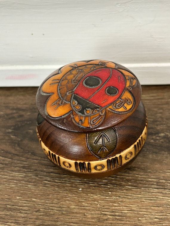 Hand, carved ladybug and flowers, wooden trinket b