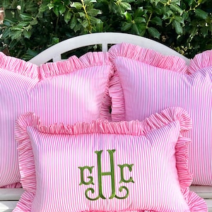 Pink and white striped pillow cover with ruffle trim