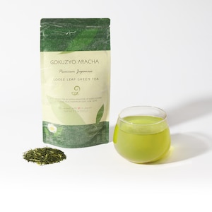 May include: A green pouch with the text "GOKUZYO ARACHA Premium Japanese LOOSE LEAF GREEN TEA" and a cup of green tea.
