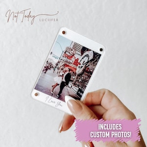 May include: A clear acrylic photo frame displaying a photograph of a couple in front of a casino. The frame has the words "I Love You" printed on it. The frame is held by a person. The text "Includes Custom Photos!" is also visible.