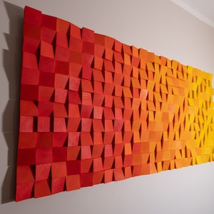 May include: A wall art piece made of wood with a gradient of red, orange, and yellow squares.