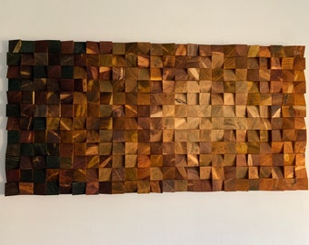 May include: A wall art piece made of wood with a gradient of colors from dark brown to light brown. The wood is arranged in a grid pattern, creating a textured surface.