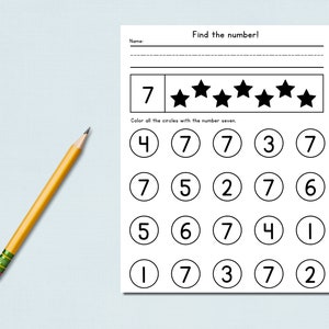 May include: A worksheet with the title "Find the number!" features a number seven and stars, with circles containing numbers. A yellow pencil with a pink eraser lies on the left. The task is to color the circles with the number seven.