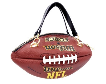 Sac ballon de football américain NFL Wilson marron et doré avec poignées en cuir noir véritable.