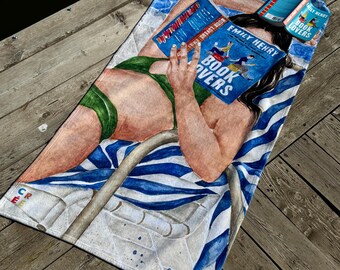 May include: A rectangular beach towel featuring a printed illustration of a person in a green bikini lying on a blue and white striped pool ladder, reading a book titled Book Lovers by Emily Henry, with a water-patterned background.