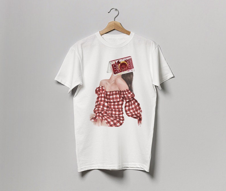 May include: White t-shirt with a graphic print of a woman wearing a red and white gingham dress. The woman's head is covered by a box with the text "CHERRY" on it.