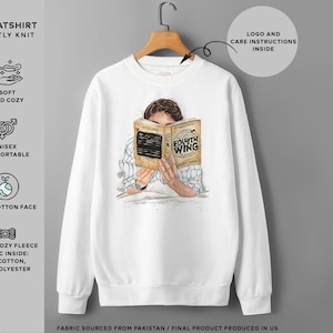 May include: White sweatshirt with a graphic of a person reading a book titled "Fourth Wing". The sweatshirt is made of a soft, cozy fleece fabric with 65% cotton and 35% polyester. The sweatshirt is unisex and made with 100% cotton face.