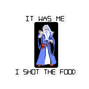 May include: A white sticker with the text "It was me I shot the food" in black letters. The sticker features a pixelated image of a wizard with a white beard and blue robe, holding a staff.