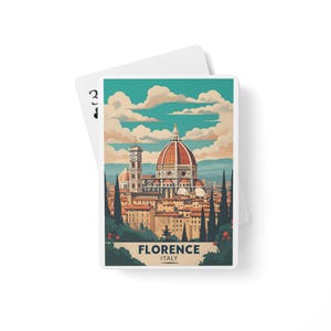 May include: Playing card featuring a colorful illustration of Florence, Italy, with the Duomo and surrounding buildings. The card has a white border and the text "FLORENCE ITALY" at the bottom. A second card is partially visible in the background.