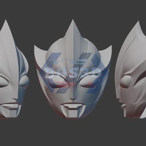 May include: Three light gray, stylized masks with pointed ears and angular features are displayed against a gray background. The masks have eye and mouth openings. The text "3D FILE" is in the bottom right corner.