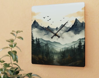 May include: Square wall clock featuring a watercolor landscape of a mountain range with a forest in the foreground. The clock face has black hands and a black frame. The artwork depicts a misty scene with birds flying in the sky.
