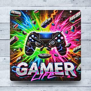 May include: Square wall clock featuring a black video game controller design with a neon blue screen and black clock hands. The clock face has the words "GAMER LIFE" in a 3D font with a colorful explosion background.
