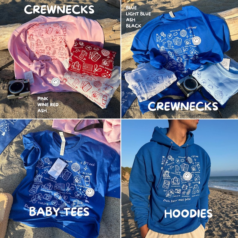 K&ouml;nnte beinhalten: Eine Auswahl an Crewnecks, Baby-T-Shirts und Hoodies in verschiedenen Farben, darunter Rosa, Blau und Aschgrau. Jedes Kleidungsst&uuml;ck zeigt ein wei&szlig;es Grafikdesign mit dem Text "DTMF" und anderen Illustrationen. Eine Kamera und gefaltete Bandanas sind ebenfalls zu sehen.