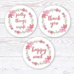 May include: Three white round stickers with pink floral wreaths and text. The first sticker says "pretty things inside". The second sticker says "thank you". The third sticker says "happy mail".