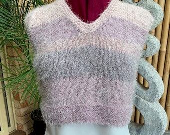 Hand knitted vest. We hand knitted this vest using a soft fluffy acrylic yarn. The variegated shades make this a versatile garment.