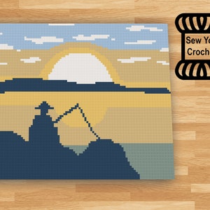 May include: A crochet pattern featuring a silhouette of a person fishing at sunset. The pattern includes a blue sky with white clouds, a yellow sun, a blue lake, and a green shoreline. The pattern is titled "Sew You Crochet".