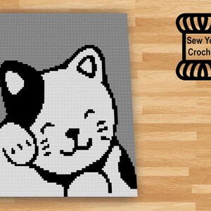 May include: A black and white crochet pattern of a cat with a happy expression. The cat is sitting with its paw raised. The pattern is on a gray background. The text "Sew You Crochet" is in a black banner above the cat.