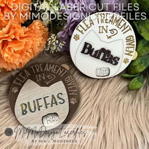 May include: Two wooden cat-shaped tags with the text "Flea Treatment Given" and the word "Buffas" in a decorative font. The tags have a space for a date, one says "Feb." and the other says "Apr."