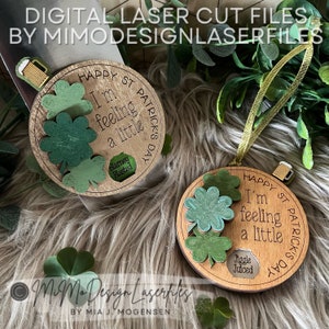 May include: Two round wooden ornaments with a St. Patrick's Day theme. The ornaments feature shamrock designs and the text "Happy St. Patrick's Day", "I'm feeling a little", "Blarney Blasted", and "Jiggle Juiced".