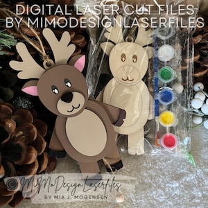 May include: Two unfinished wooden reindeer ornaments with paint and a brush. The reindeer are ready to be painted.  The reindeer are in a clear plastic bag with the paint and brush.  The text "DIGITAL LASER CUT FILES BY MIMODESIGNLASERFILES" is at the top of the image.  The text "MiMo Design Laserfiles BY MIA J. MOGENSEN" is at the bottom of the image.