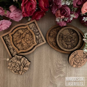 May include: Set of four wooden coasters with a floral design. The coasters are in different shapes and sizes, and they are all made of a light brown wood. The coasters are arranged on a wooden surface.